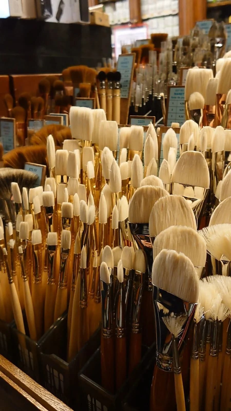 Brushes and tubes of paint laid out on a bench