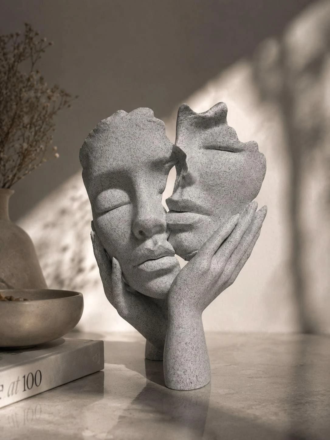A pale relief of two faces turned from one another