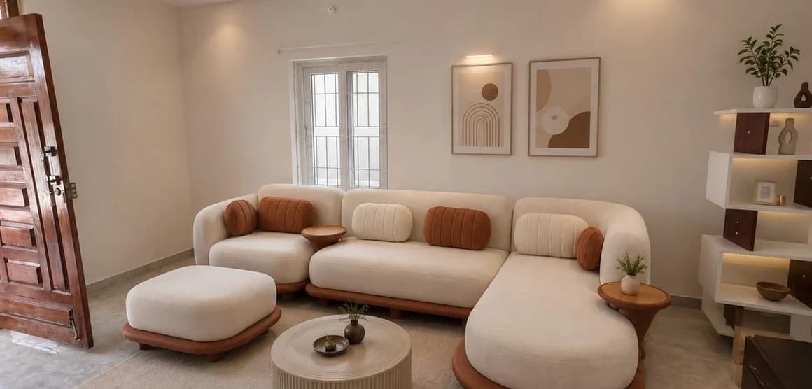 A tan sofa, round table and open shelving in a bright room