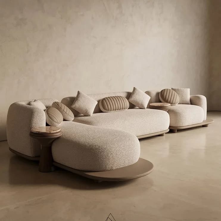 A curved modular sofa on a warm plaster floor