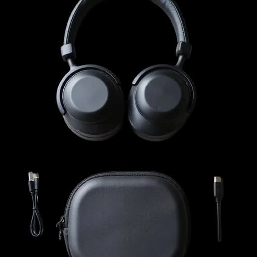 Over-ear headphones beside a hard case and cable