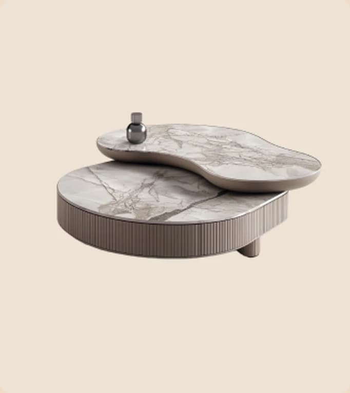 A marble coffee table with a shaped top on a fluted base