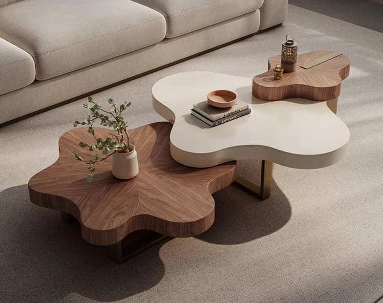 A cloud-shaped walnut coffee table beside a white one