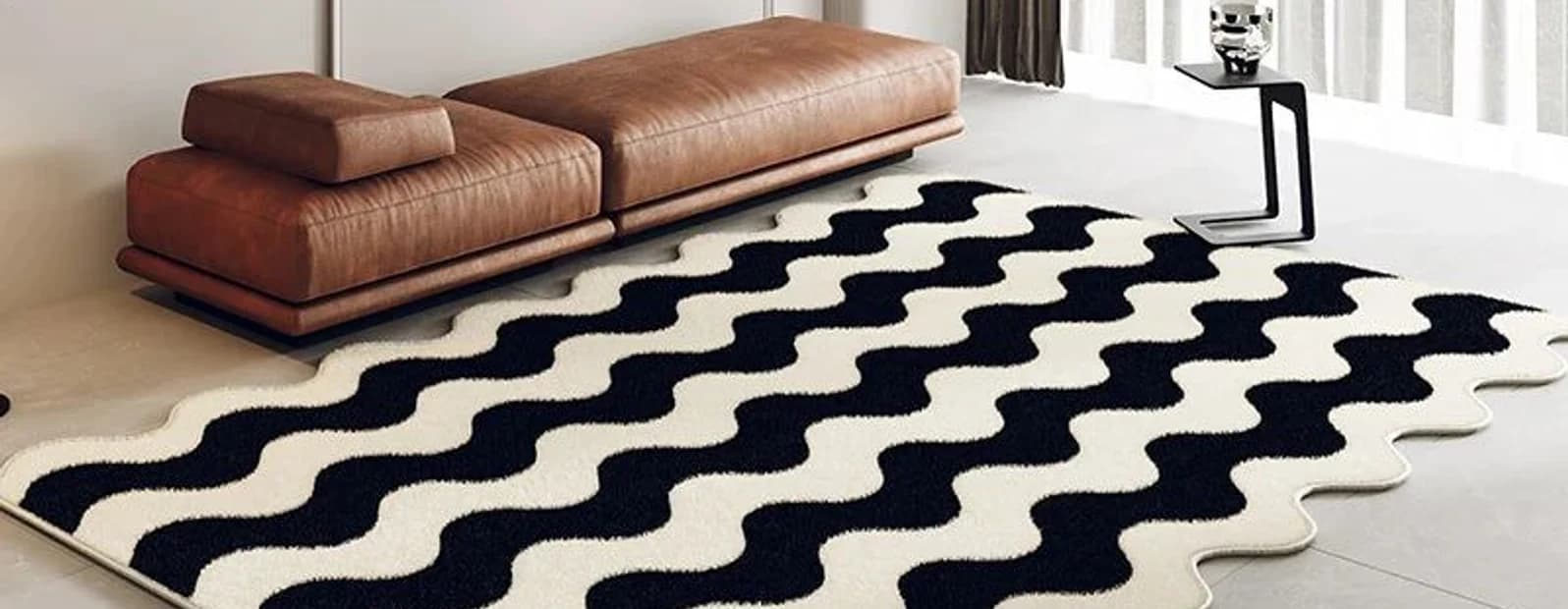 A tan leather bench on a black and white wave-pattern rug