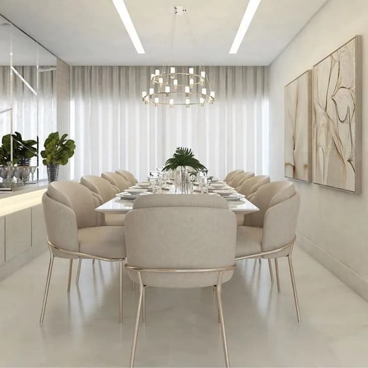A round dining table under a branched chandelier