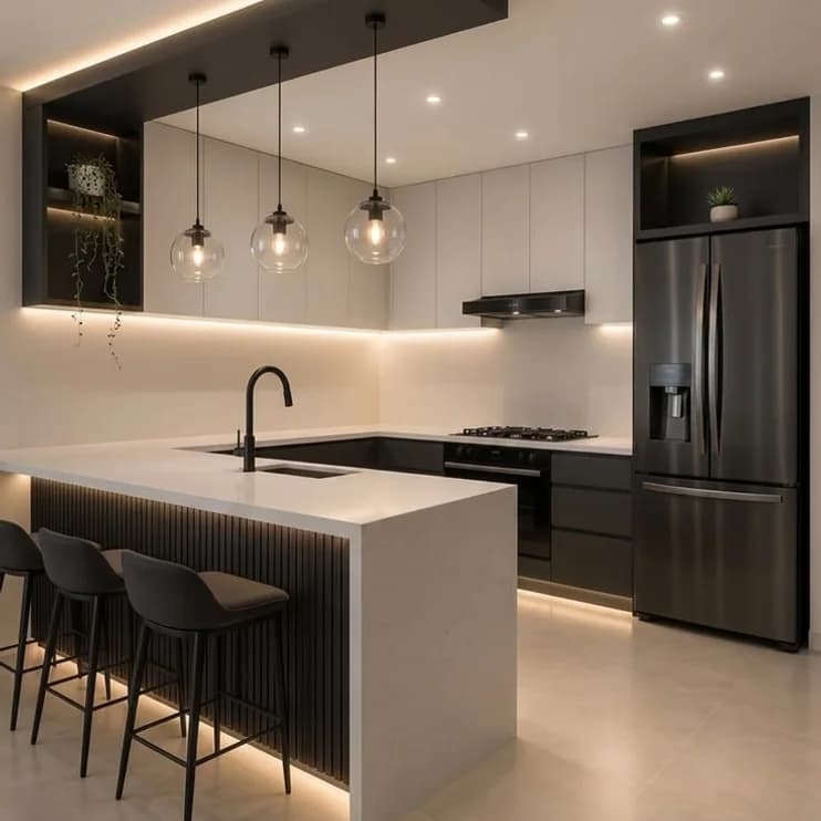 A dark island kitchen with pendant lights over the counter