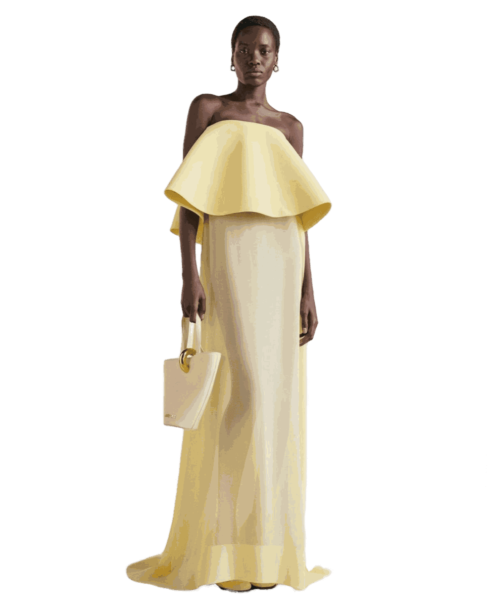 A pale yellow column gown with a ruffled off-shoulder collar