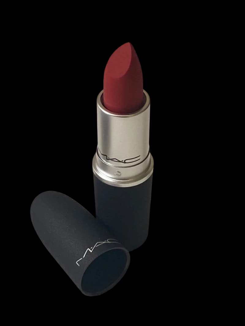 An open bullet of deep red matte lipstick