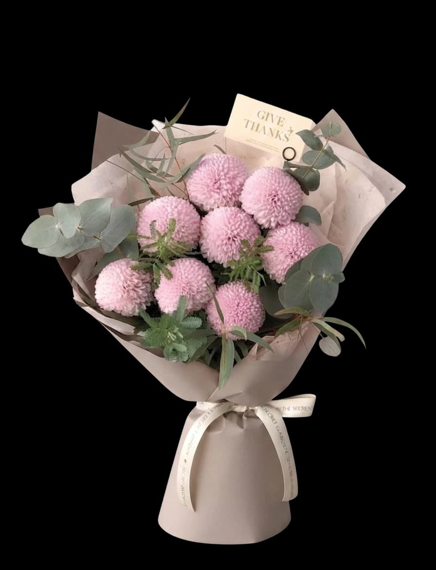 Pink pompom chrysanthemums with eucalyptus in a taupe wrap