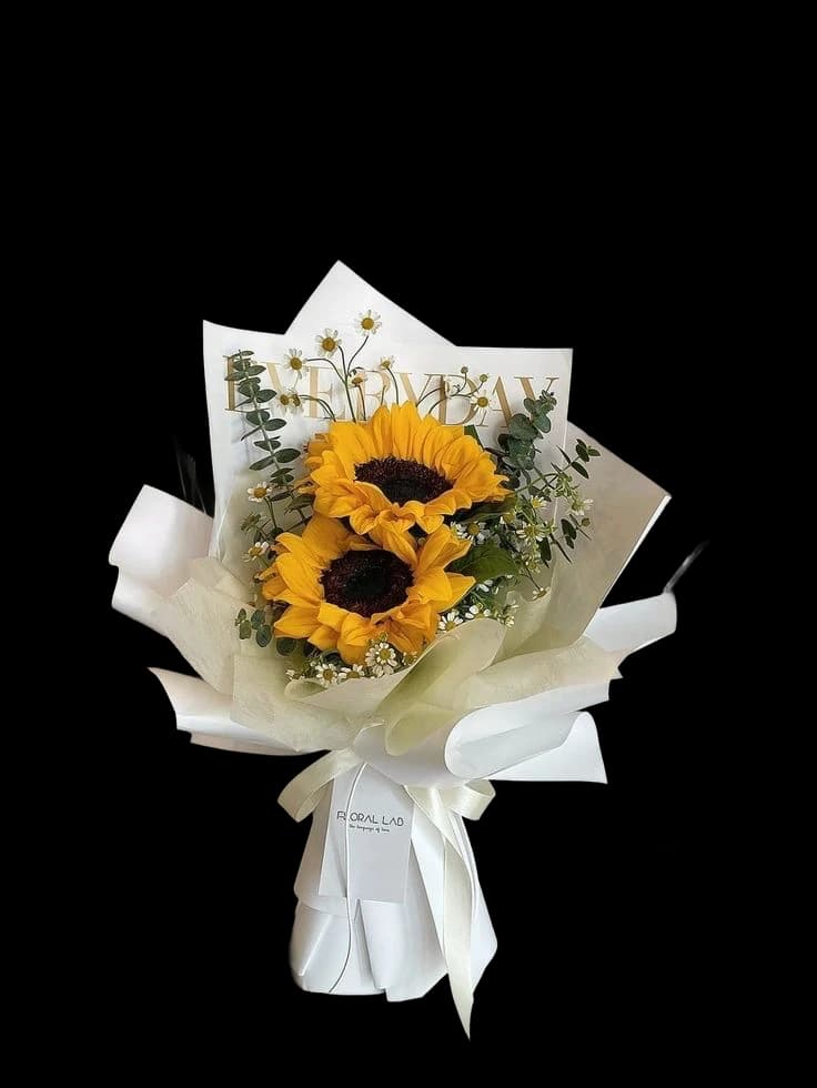 Sunflowers with eucalyptus and gypsophila in a white paper wrap
