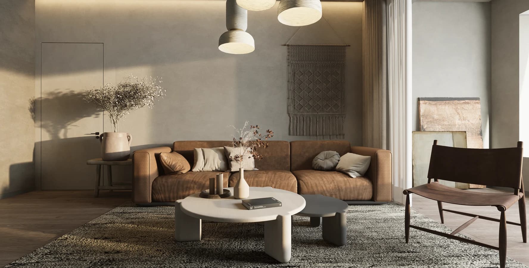 A daylit living room with a tan leather sofa, paper pendants and a woven rug