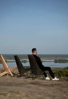 Two loungers set out facing the water