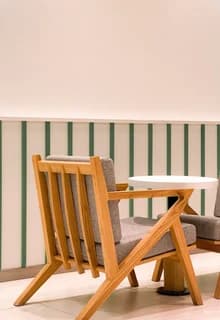 A striped deck chair against a pink wall