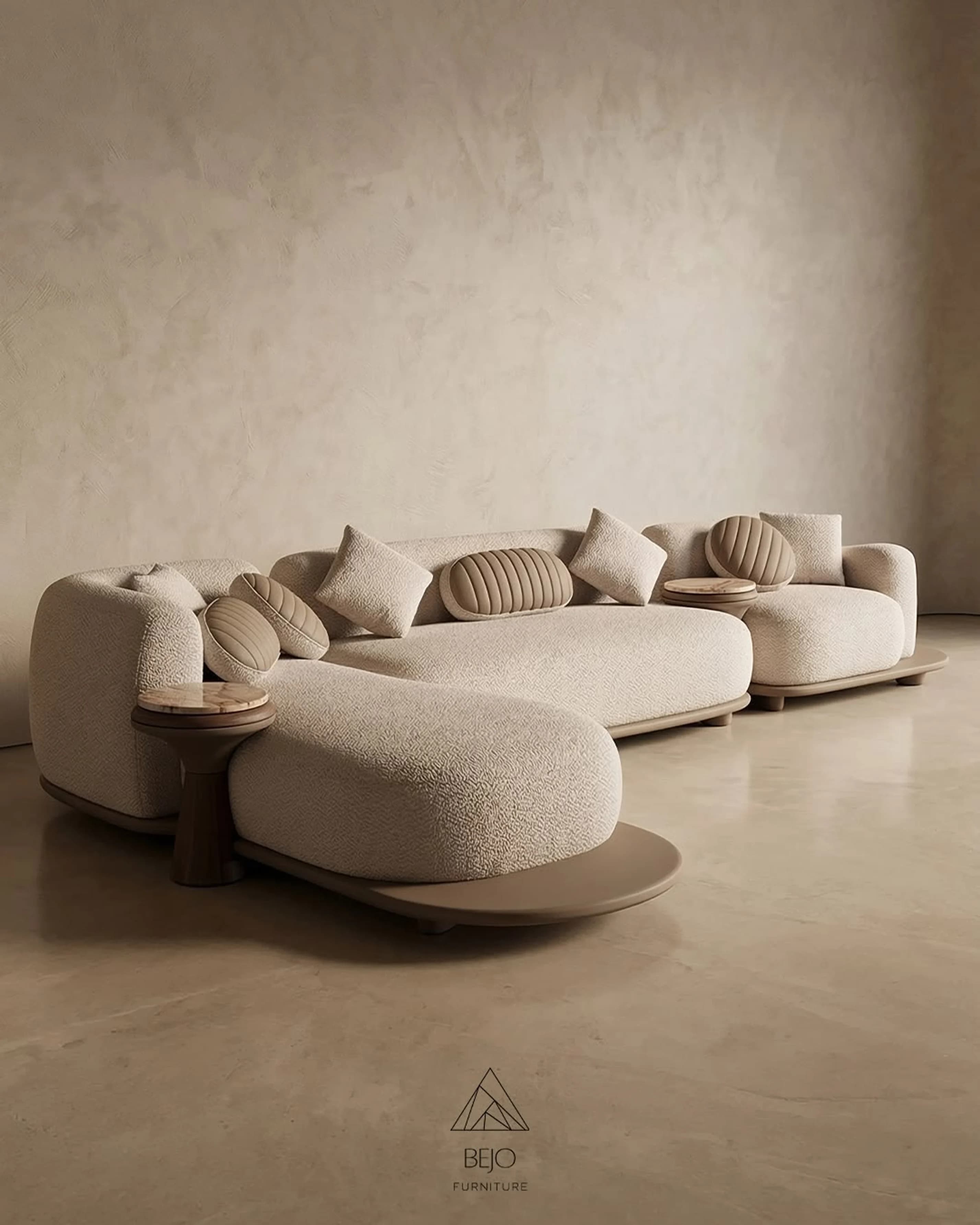 A curved bouclé sectional and matching armchairs in a plaster-walled room