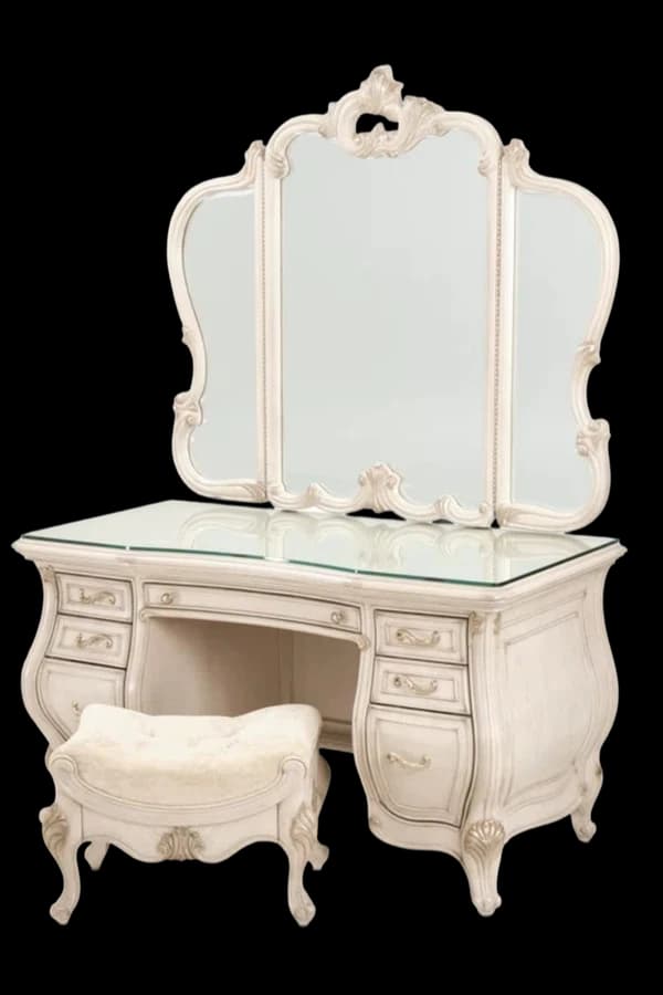 A carved white dressing table with a mirror and stool