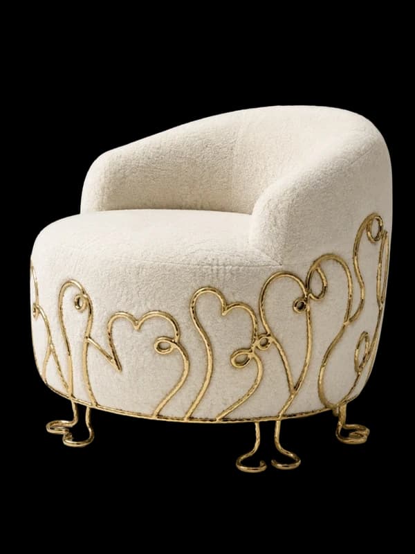 A bouclé tub chair on gilded scroll feet