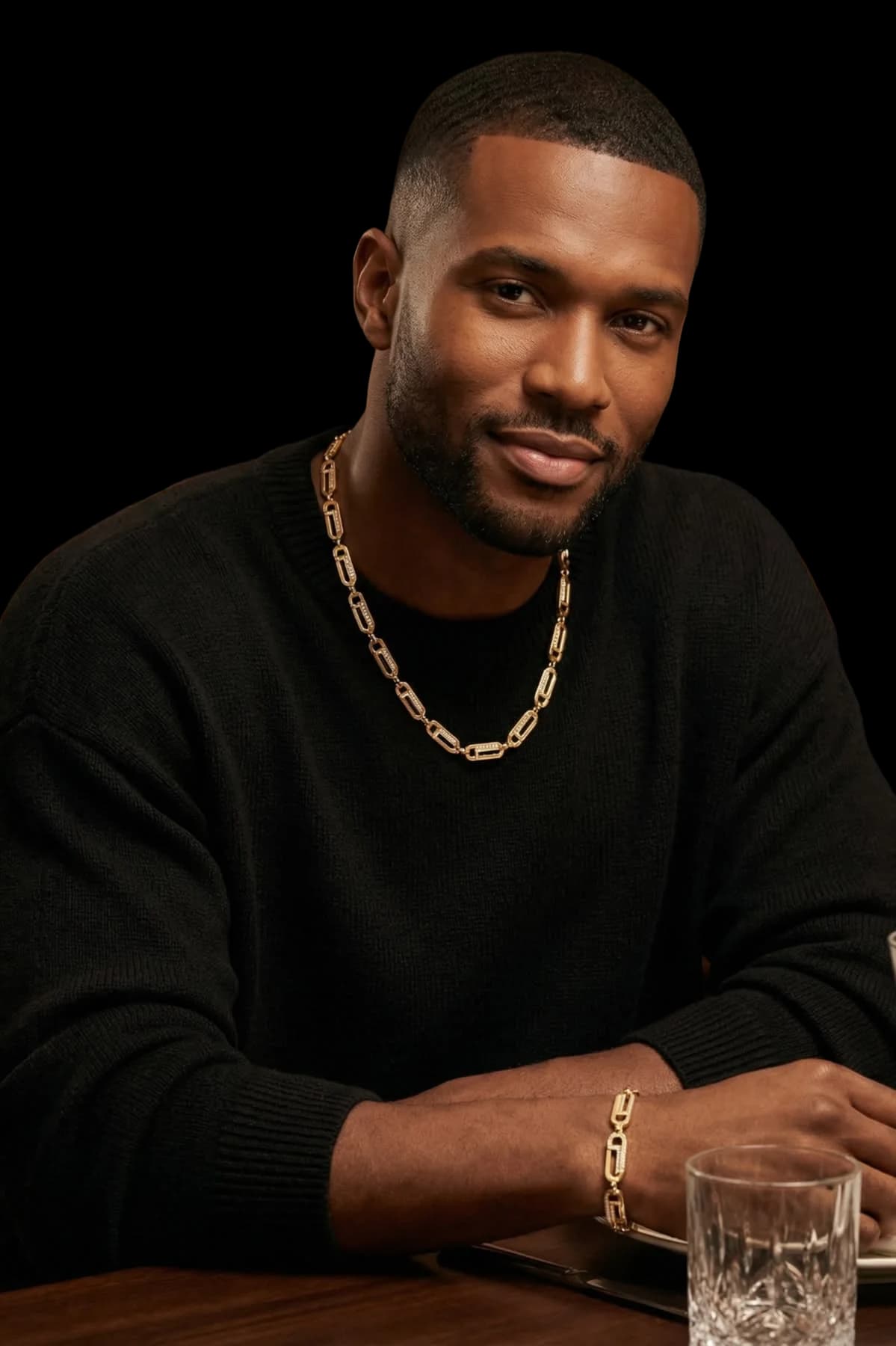 A man in a heavy gold curb chain
