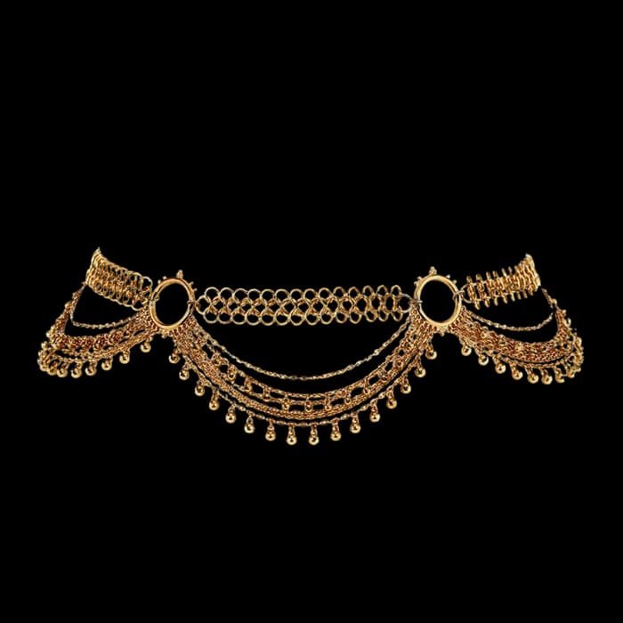 A draped gold body chain