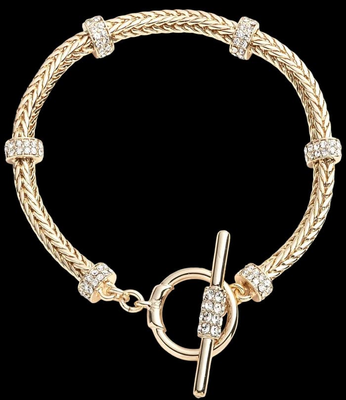 A gold toggle bracelet set with pale stones