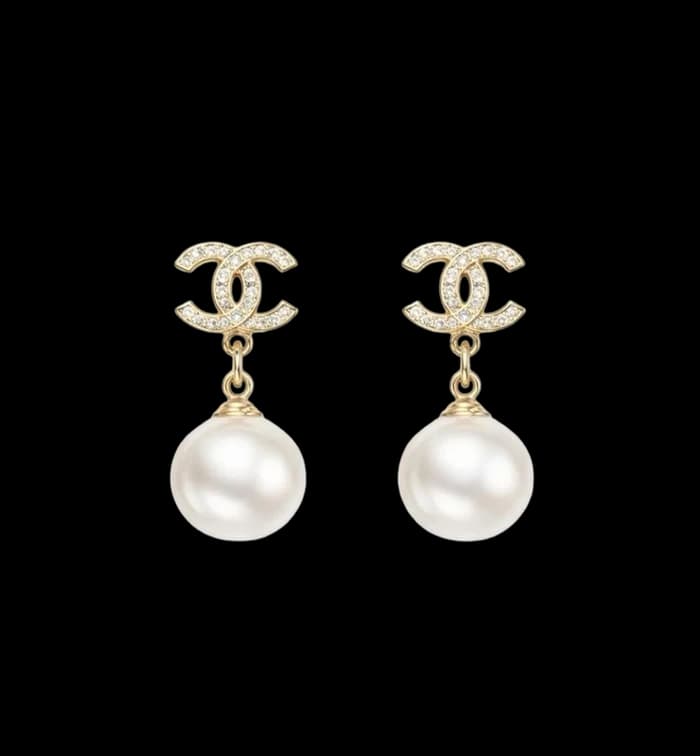 A pair of pearl drop earrings on gold fittings