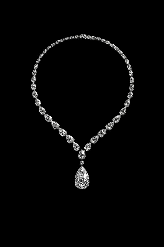A fine stone-set necklace falling to a pear drop