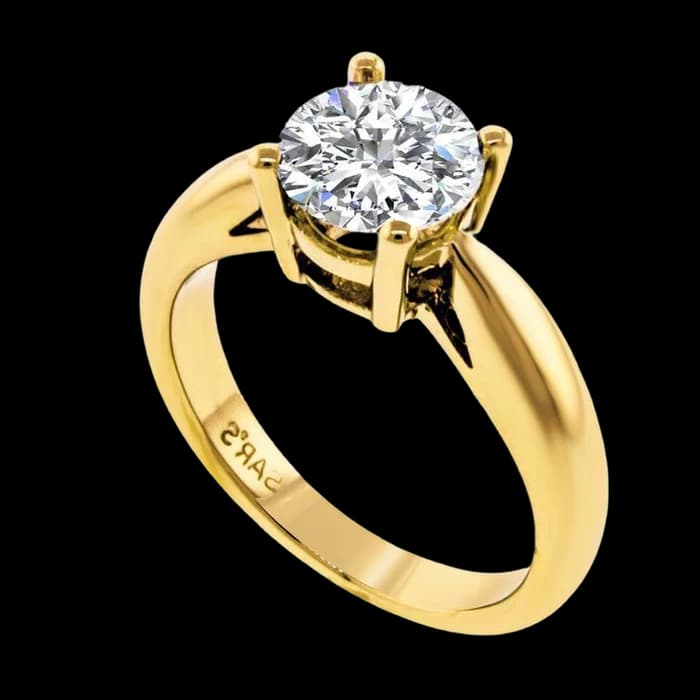 A yellow gold solitaire with a large round brilliant