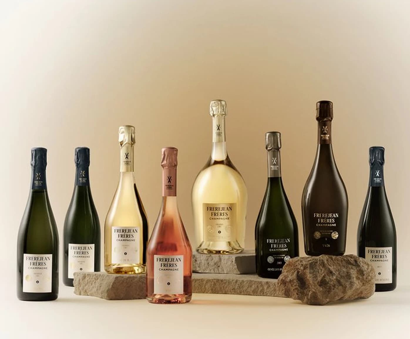 Eight champagne bottles and a magnum arranged on stone plinths