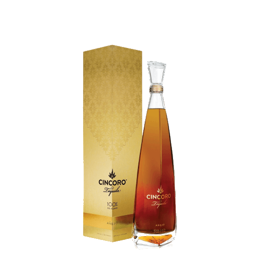 A tall agave spirit bottle beside a gold gift box