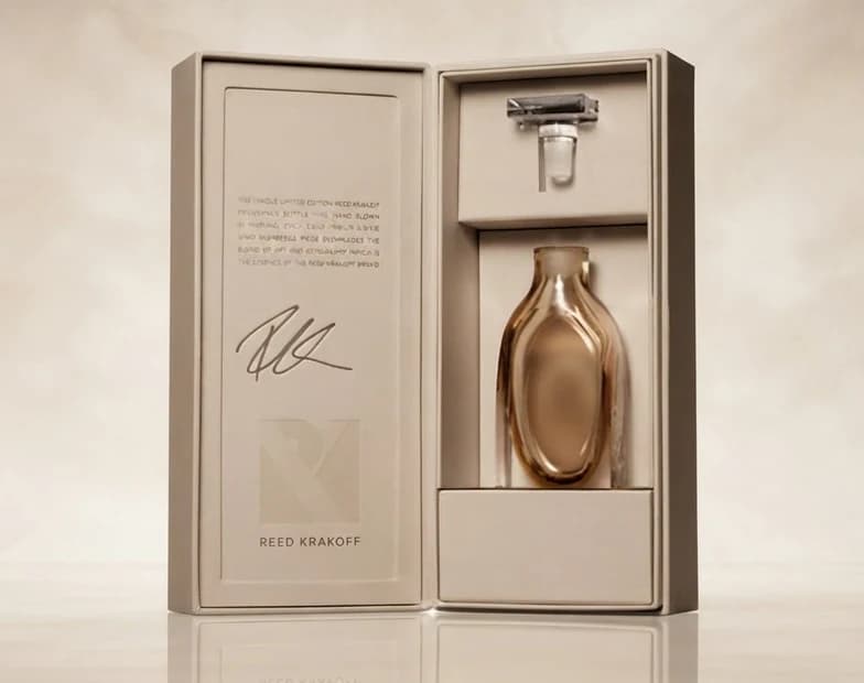 A gold bottle presented in a lined display case
