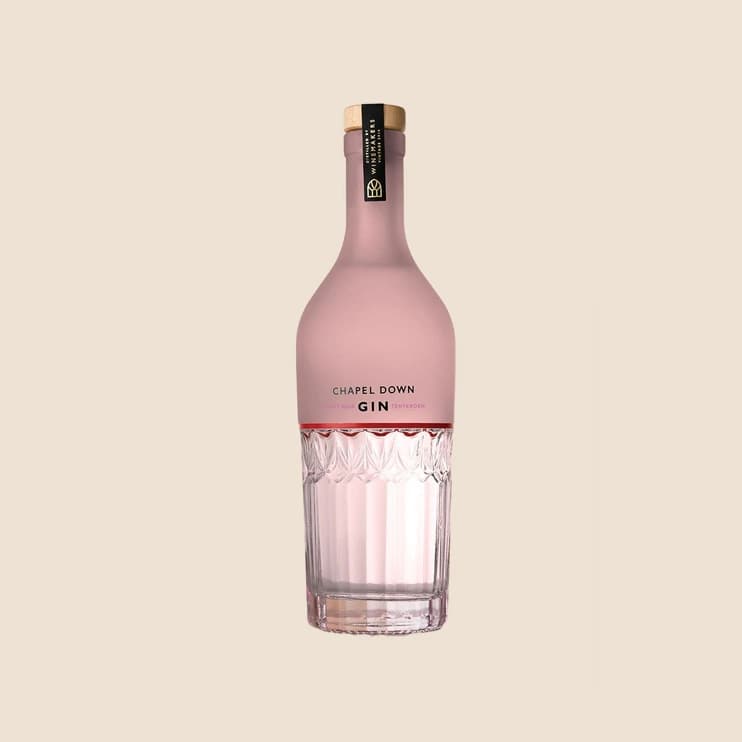A tapered pink gin bottle with an embossed base