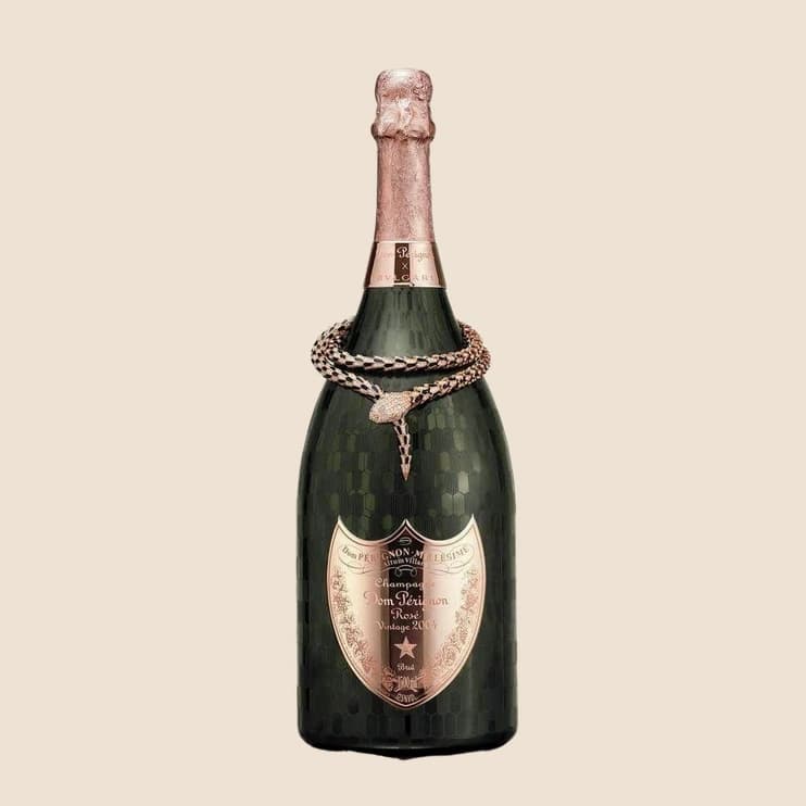 A dark champagne bottle with a rope collar and a rose gold label
