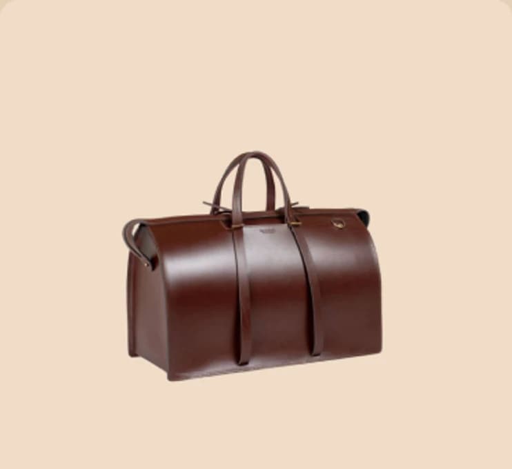 A tan leather holdall with a brass clasp