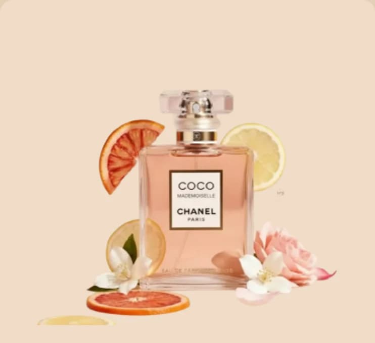 A flacon of amber scent among citrus slices and blossom