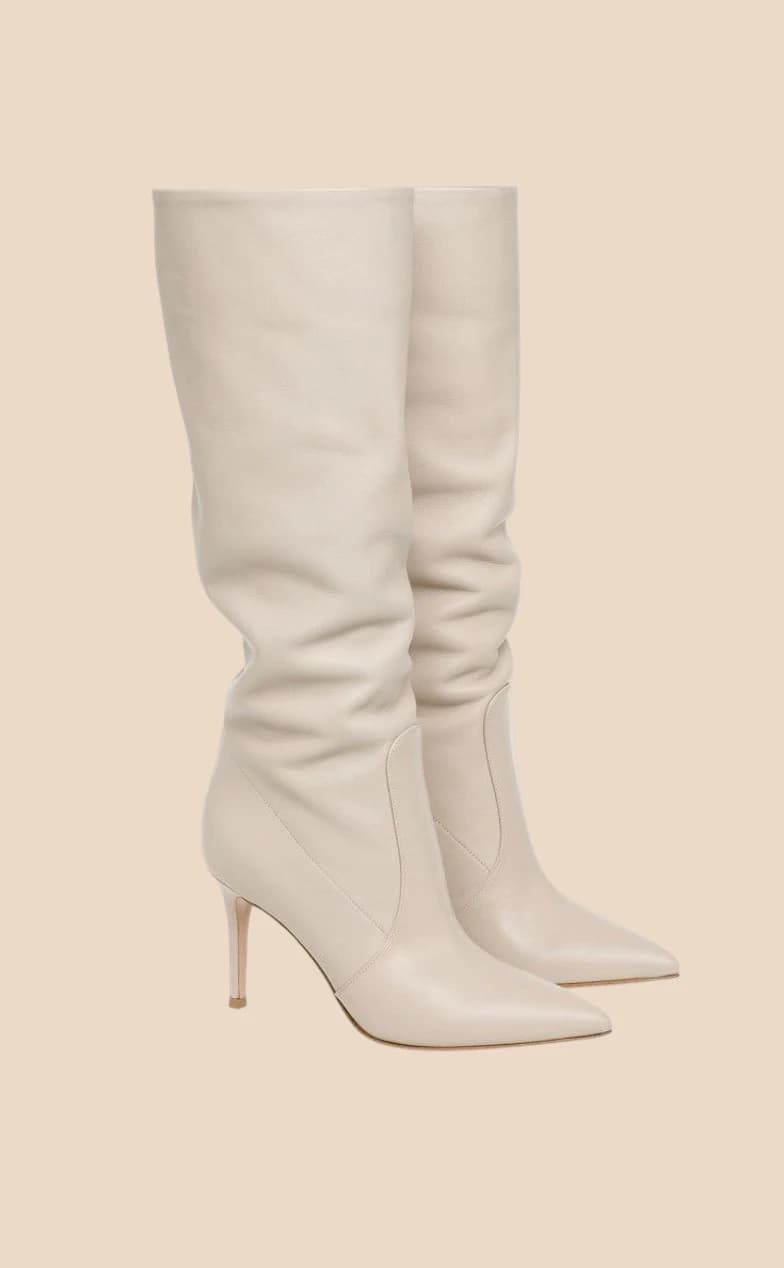 Ivory leather knee boots slouched at the ankle on a stiletto heel