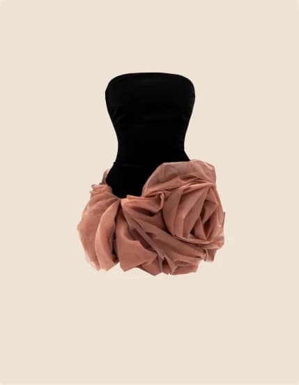 A black bustier gown with a large blush rosette