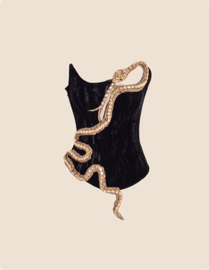 A black velvet bustier with a gold serpent motif