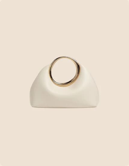 An ivory clutch gathered through a gold ring handle