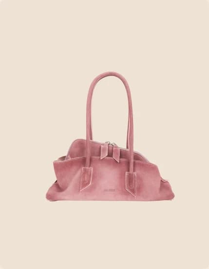 A rose suede bag gathered into a soft pillow shape