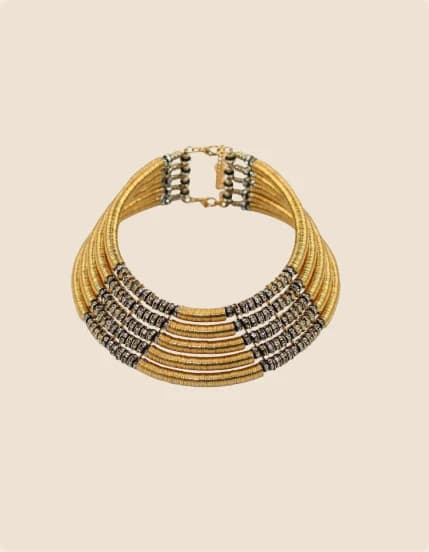 A wide gold collar banded with diamond rows