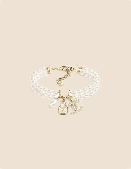 A double pearl bracelet with gold charms
