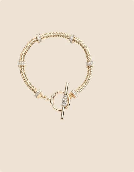 A gold chain bracelet with a toggle clasp