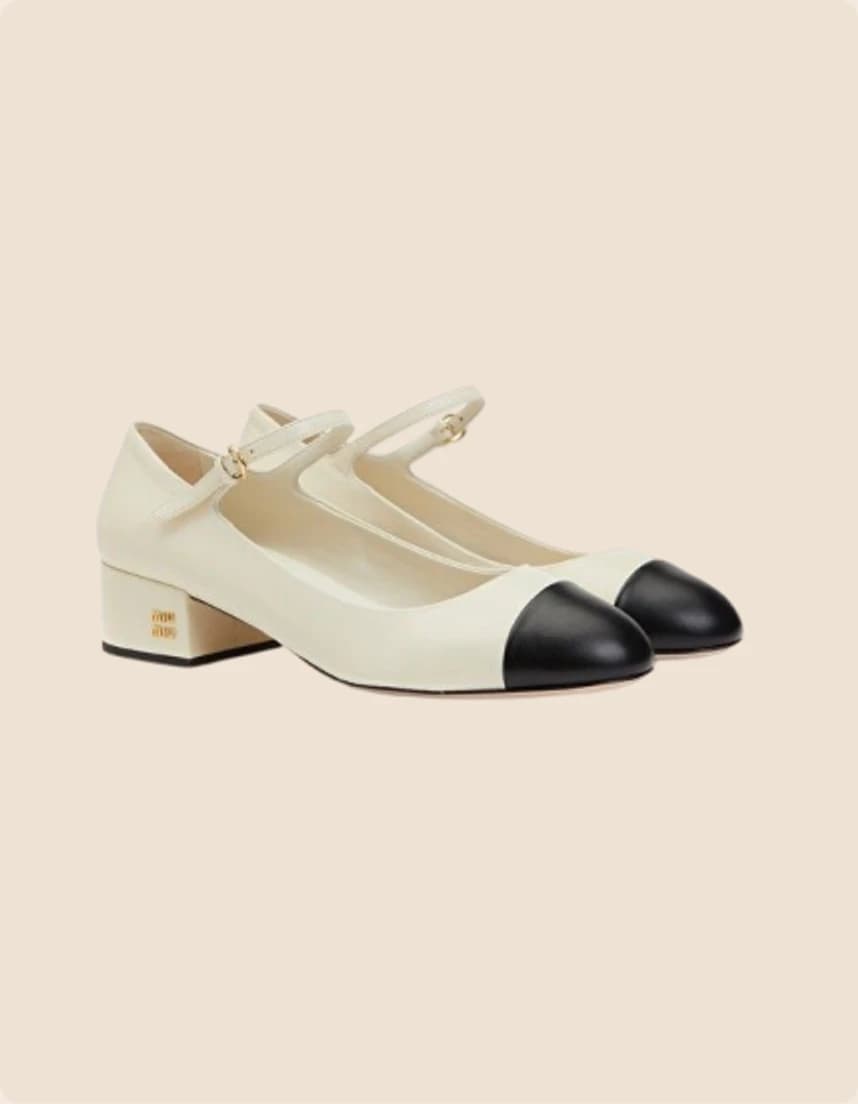 A cream leather Mary Jane with a black cap toe