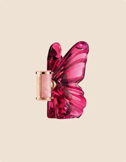 A fuchsia butterfly-shaped perfume bottle