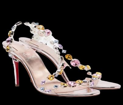 A sandal strapped with jewelled flowers on a clear heel