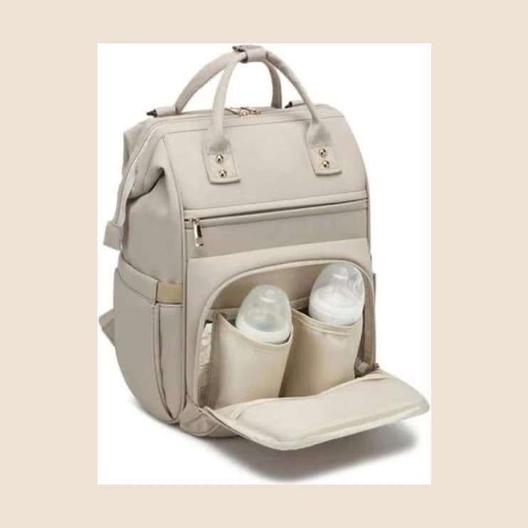 A cream diaper backpack open to show bottle pockets