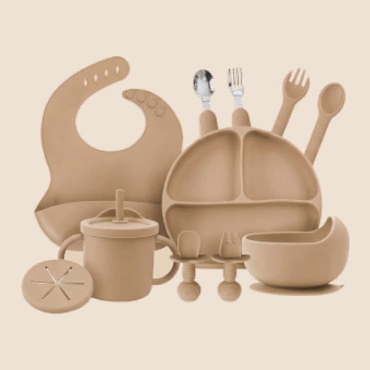A clay-coloured silicone plate, bowl and spoon set