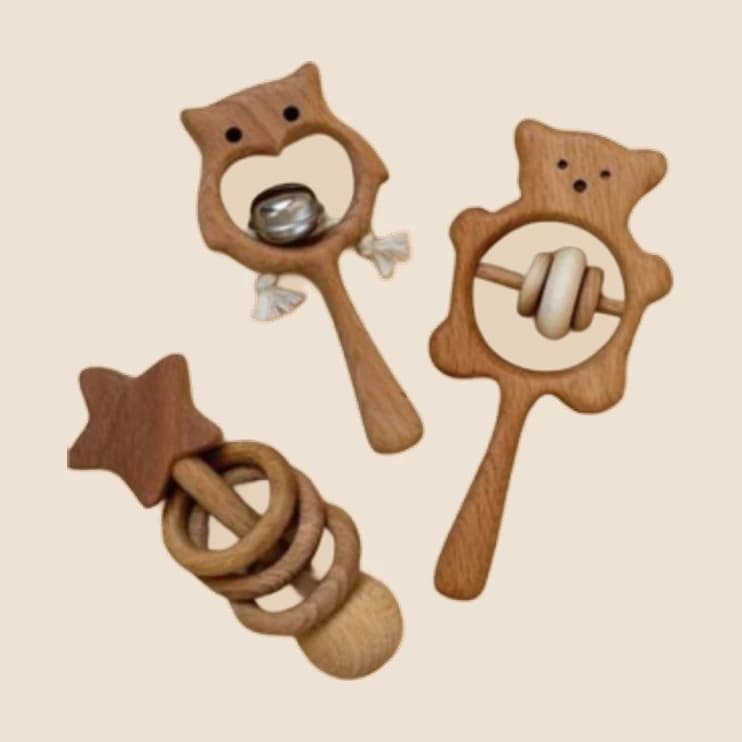 A wooden pram garland with hanging rattles