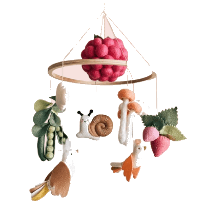 A cot mobile hung with felt fruit and woodland animals
