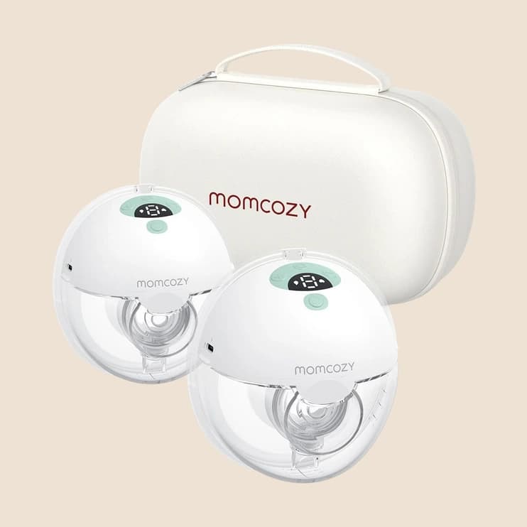 A pair of wearable breast pumps beside their charging case